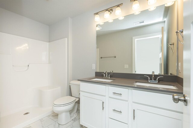 bathroom with walk in shower, vanity, and toilet