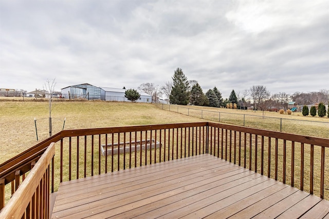 wooden terrace featuring a yard