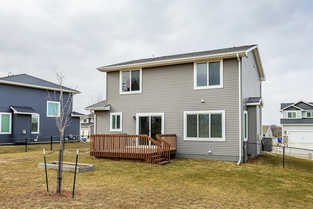 back of property with central air condition unit, a deck, and a yard