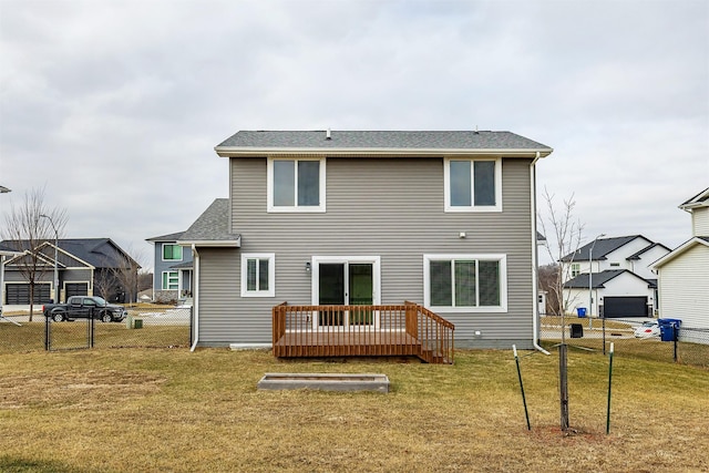 back of property featuring a lawn and a deck