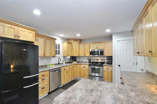 kitchen featuring sink, stainless steel appliances, and light brown cabinetry