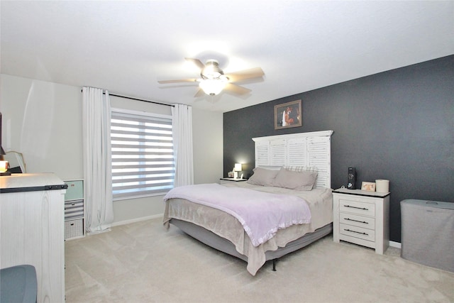 bedroom featuring light carpet and ceiling fan