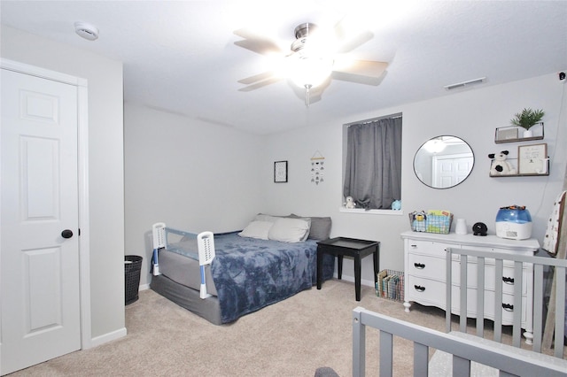 bedroom featuring light carpet and ceiling fan