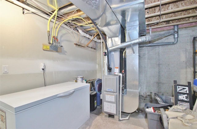 utility room featuring heating unit