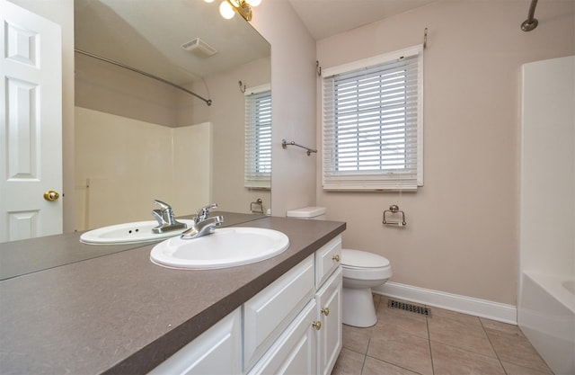 full bathroom featuring vanity, tile patterned floors, washtub / shower combination, and toilet