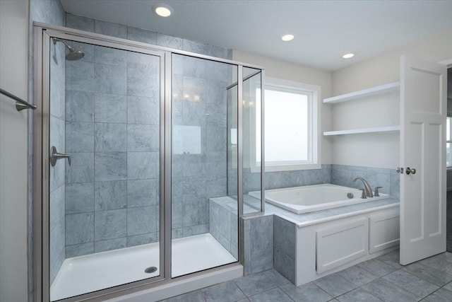 bathroom with independent shower and bath and tile patterned flooring