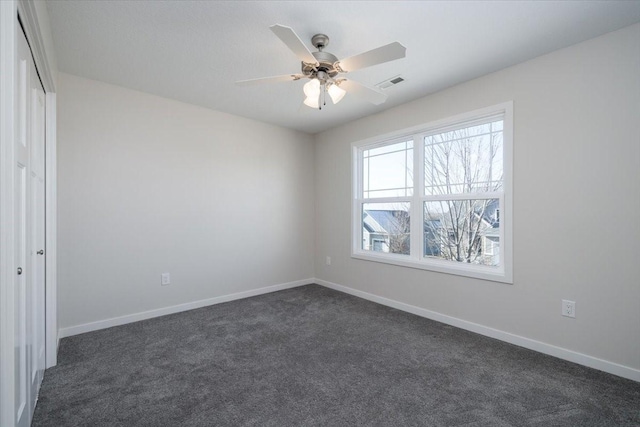 carpeted spare room with ceiling fan