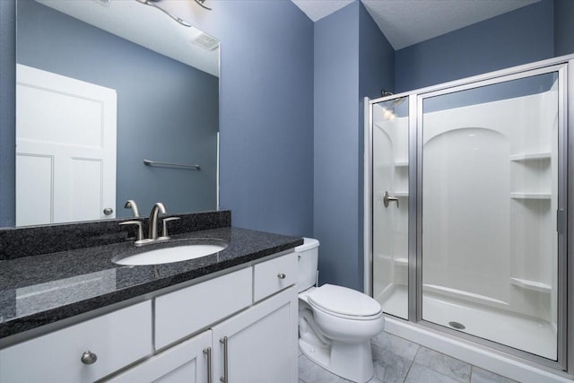 bathroom with a textured ceiling, walk in shower, vanity, and toilet