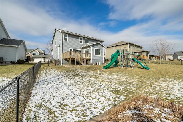 snow covered property featuring central AC and a playground