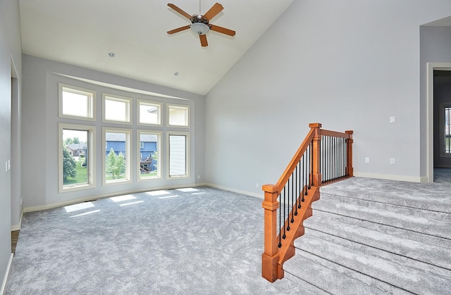 carpeted living room with high vaulted ceiling and ceiling fan