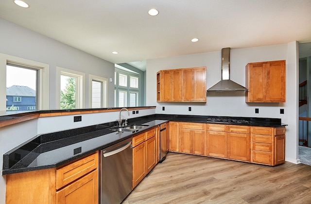 kitchen with sink, light hardwood / wood-style floors, stainless steel dishwasher, wall chimney range hood, and black gas stovetop