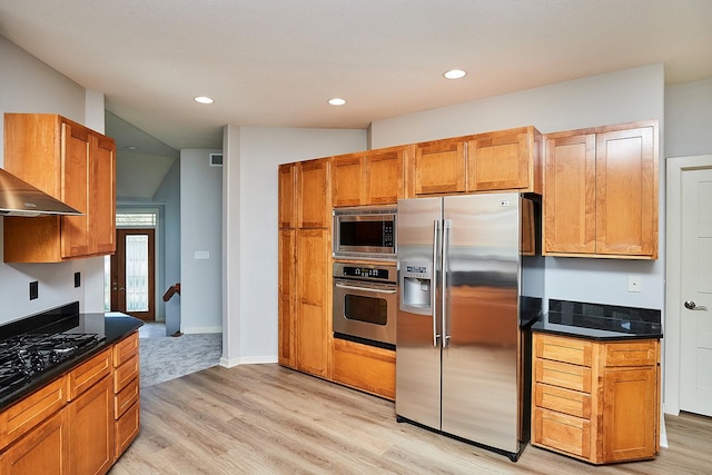 kitchen with dark countertops, recessed lighting, visible vents, light wood-style flooring, and appliances with stainless steel finishes