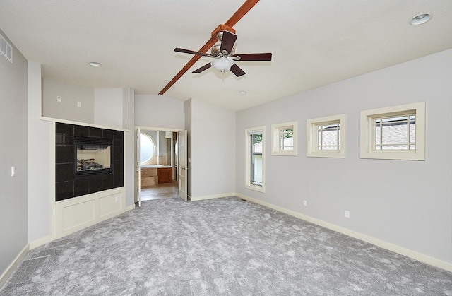 unfurnished living room with a fireplace, ceiling fan, and carpet flooring