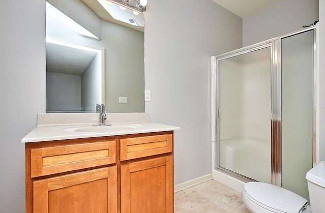 bathroom with visible vents, toilet, a stall shower, vanity, and baseboards