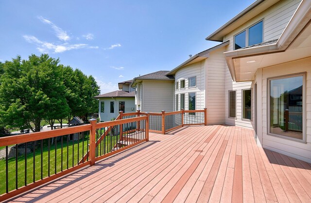 wooden terrace featuring a lawn