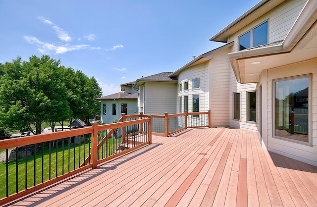 wooden deck featuring a lawn