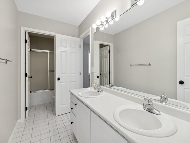 full bathroom with shower / bath combination with glass door, tile patterned flooring, toilet, and vanity