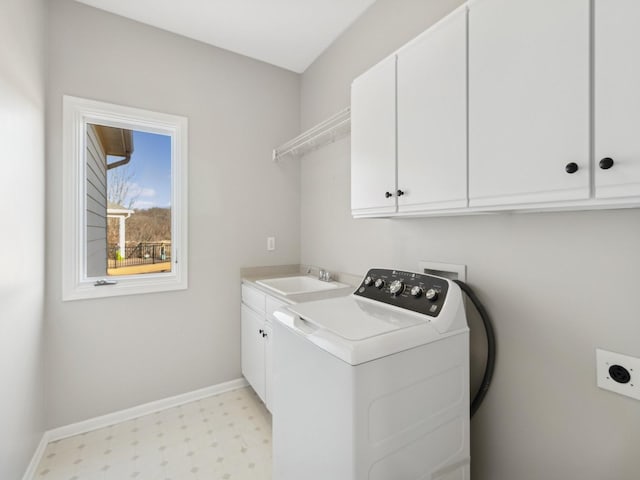 laundry area featuring sink, cabinets, and washer / dryer