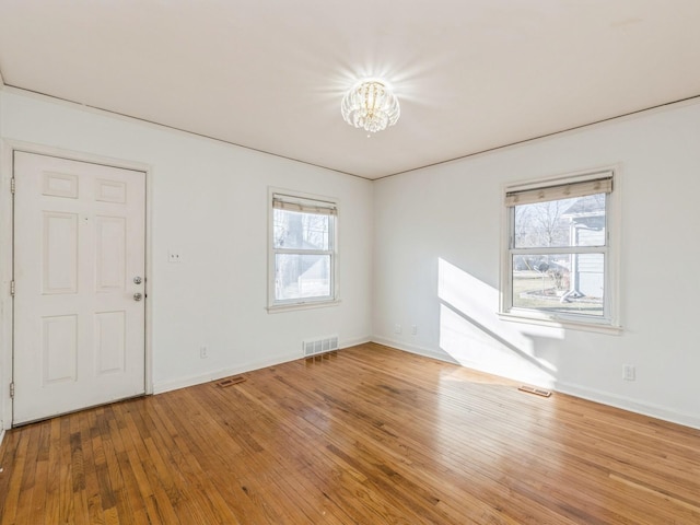 entryway with a notable chandelier and wood-type flooring