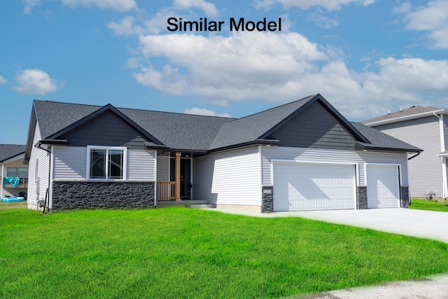 view of front of home with a front yard and a garage