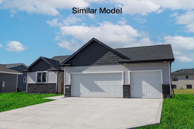 craftsman inspired home with a front lawn, a garage, and central air condition unit