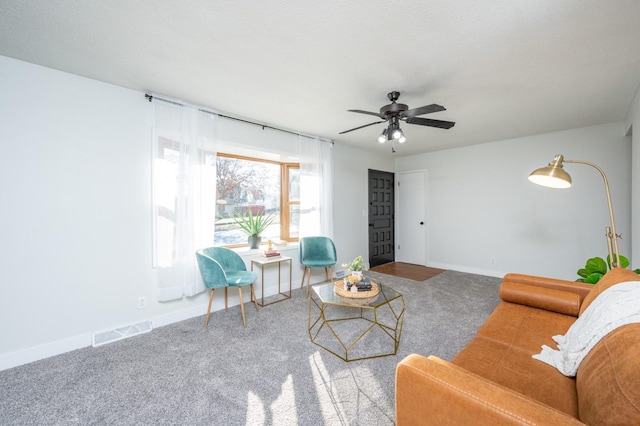 living room with ceiling fan and carpet