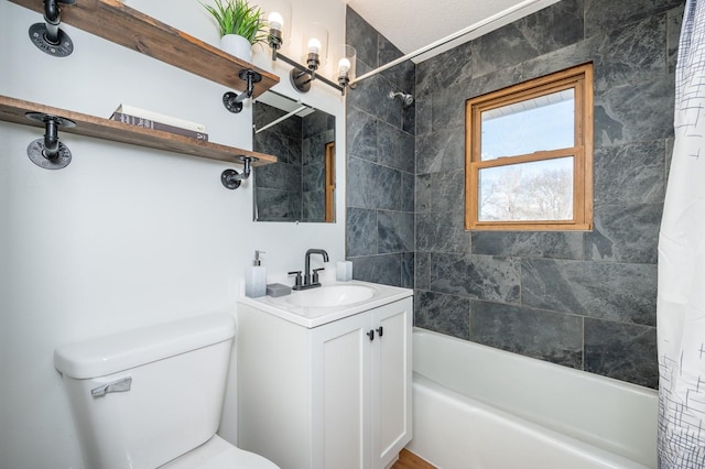 full bathroom featuring toilet, shower / bathtub combination with curtain, and vanity