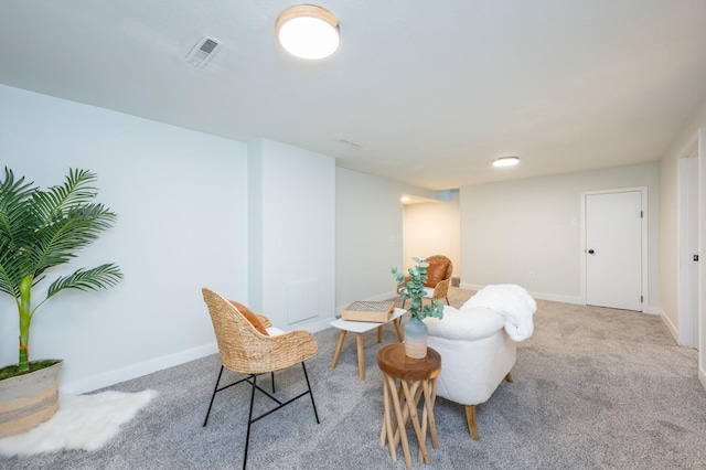 sitting room featuring light colored carpet