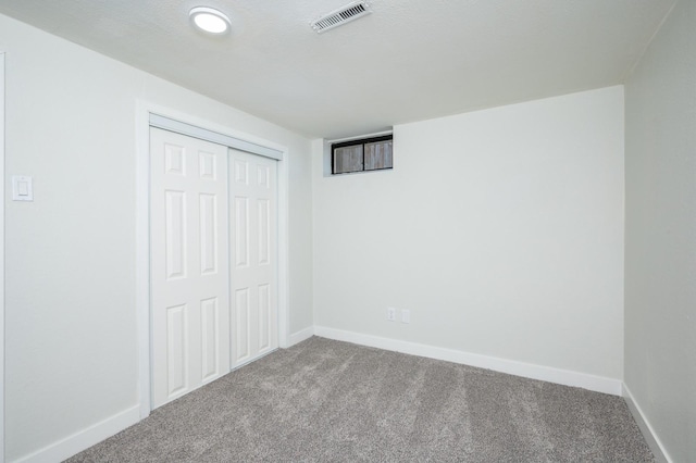 unfurnished bedroom featuring a closet and carpet flooring