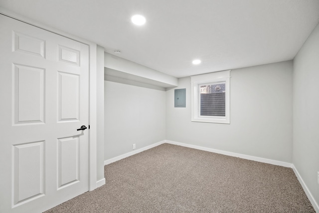 basement with electric panel and carpet