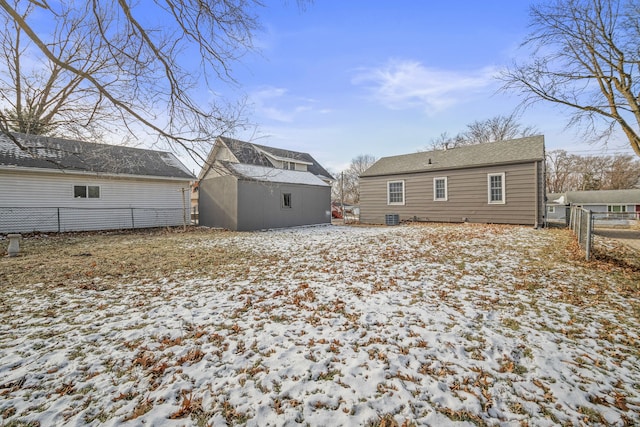 snow covered house with central AC unit