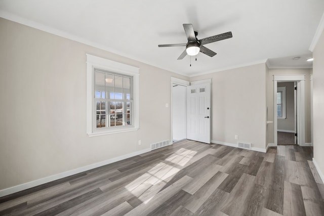 spare room with ceiling fan, ornamental molding, and dark hardwood / wood-style floors