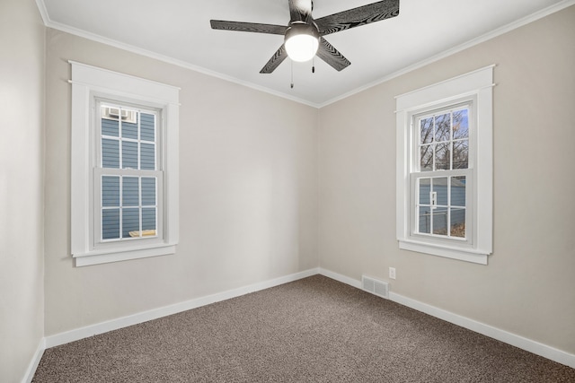 spare room with ceiling fan, crown molding, and carpet floors