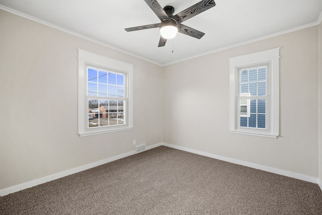 spare room featuring ornamental molding, ceiling fan, carpet flooring, and a healthy amount of sunlight