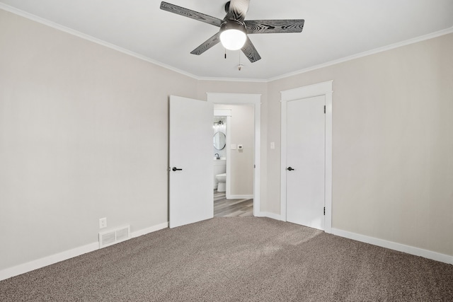 carpeted spare room with ceiling fan and crown molding