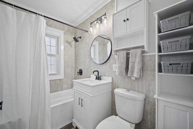 full bathroom featuring toilet, vanity, tile walls, and shower / bath combination with curtain