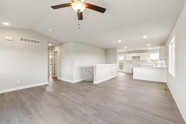 2008 White Oak Ln, Granger, IA 50109 - unfurnished living room with light wood-style floors, recessed lighting, a ceiling fan, and vaulted ceiling