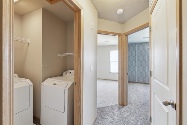 laundry room with washing machine and dryer and light carpet