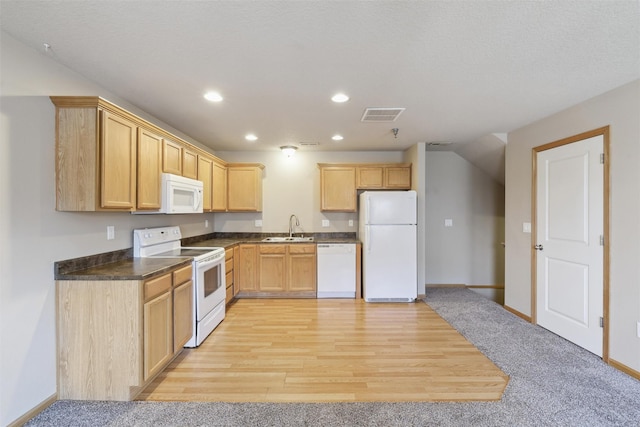 kitchen featuring white appliances, light colored carpet, light brown cabinetry, and sink