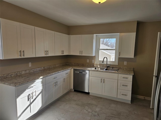 kitchen with light stone counters, stainless steel appliances, white cabinets, and sink