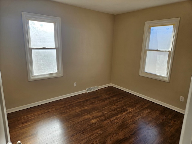 empty room featuring dark hardwood / wood-style flooring