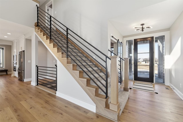 18256 Alderleaf Dr, Clive, IA 50325 - foyer featuring recessed lighting, baseboards, light wood-type flooring, and stairs