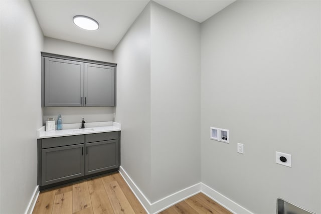 18256 Alderleaf Dr, Clive, IA 50325 - laundry room featuring electric dryer hookup, cabinet space, baseboards, hookup for a washing machine, and light wood-style flooring