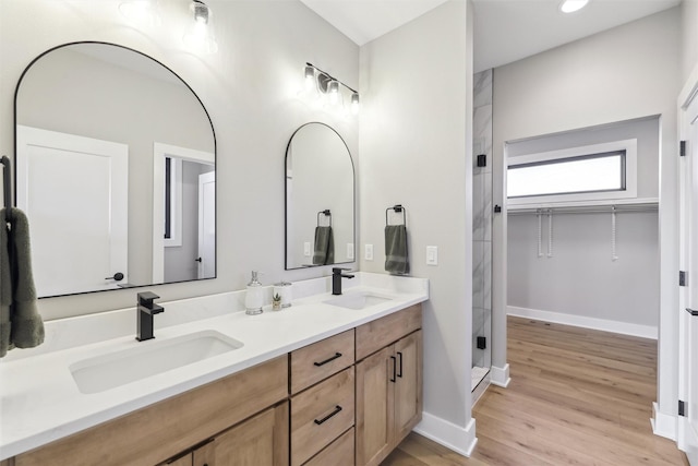 18256 Alderleaf Dr, Clive, IA 50325 - full bathroom with double vanity, baseboards, a sink, and wood finished floors