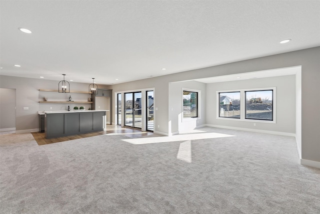 18256 Alderleaf Dr, Clive, IA 50325 - unfurnished living room featuring baseboards, recessed lighting, and light colored carpet