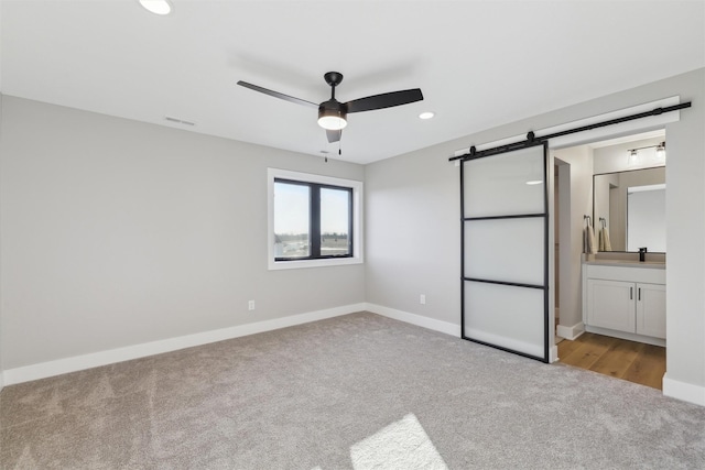 18256 Alderleaf Dr, Clive, IA 50325 - unfurnished bedroom with baseboards, carpet flooring, a barn door, and visible vents