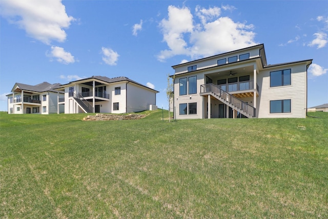 18256 Alderleaf Dr, Clive, IA 50325 - back of house with a lawn, a ceiling fan, and stairs