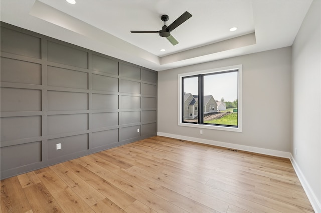 18256 Alderleaf Dr, Clive, IA 50325 - unfurnished room featuring a decorative wall, light wood-style flooring, a raised ceiling, ceiling fan, and recessed lighting