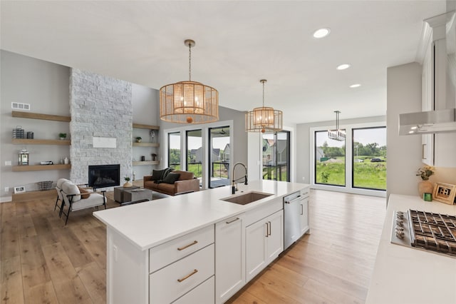 18256 Alderleaf Dr, Clive, IA 50325 - kitchen with a sink, appliances with stainless steel finishes, light wood finished floors, healthy amount of natural light, and recessed lighting