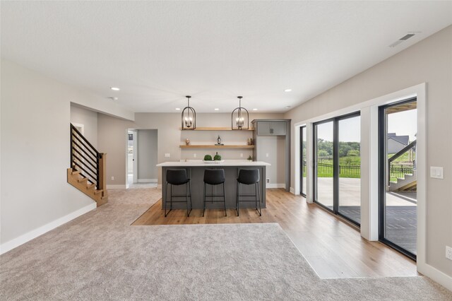 18256 Alderleaf Dr, Clive, IA 50325 - kitchen featuring open shelves, recessed lighting, a chandelier, light countertops, and a kitchen bar